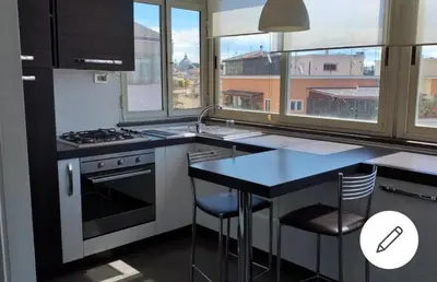 a kitchen with a counter and a sink and a stove at Attico 22 in Rome