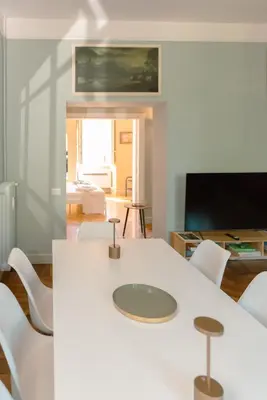 a living room with a white table and white chairs at Tiber Luxury Apartment in Rome