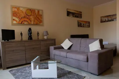 a living room with a couch and a tv at Spanish Steps Studio in Rome