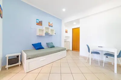 a bedroom with a bed and a desk and a table at Bubu's Home by Holiday World in Rome