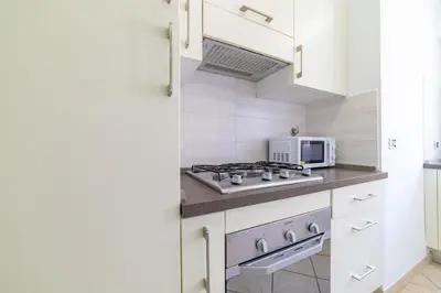 a kitchen with a stove and a microwave at Bubu's Home by Holiday World in Rome