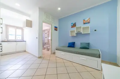 a bedroom with a bed and a blue wall at Bubu's Home by Holiday World in Rome