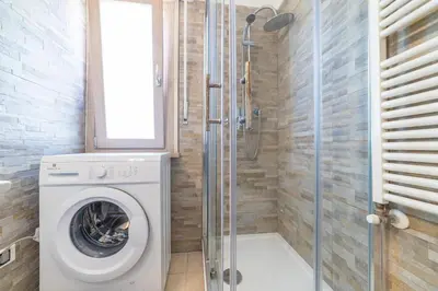 a bathroom with a washing machine and a shower at Bubu's Home by Holiday World in Rome