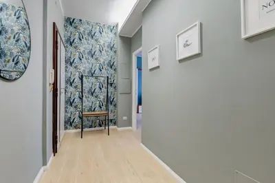 a hallway with a blue and white wall at Domus Suite Gemelli - Relax & Comfort in Rome
