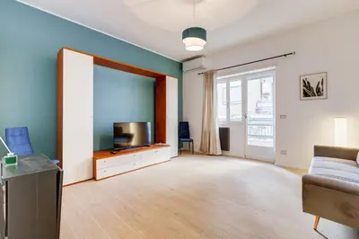a living room with a couch and a flat screen tv at Domus Suite Gemelli - Relax & Comfort in Rome