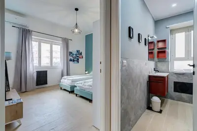 a bedroom with a bed and a bathroom at Domus Suite Gemelli - Relax & Comfort in Rome