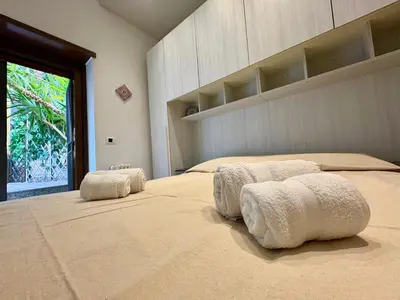 a large bedroom with two beds with towels on them at Vatican Walls Studio in Rome