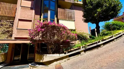 a building with flowers in a pot on the side of a street at Vatican Walls Studio in Rome