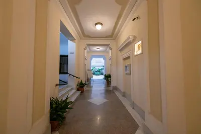 a hallway of a building with potted plants at Dimora Armanda Roma in Rome