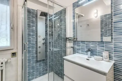 a bathroom with a sink and a glass shower at Maison Sofia in Rome