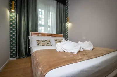 a bedroom with a bed with white towels on it at The Suitest Roma Apartment Appio Latino in Rome