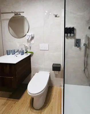 a bathroom with a toilet and a shower at The Suitest Roma Apartment Appio Latino in Rome