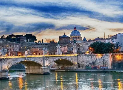 a bridge over a river with a city at The Suitest Roma Apartment Appio Latino in Rome