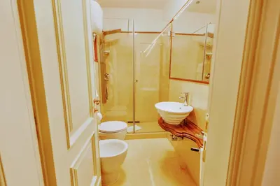 a bathroom with a shower and a toilet and a sink at Casa Arpinelli in Rome