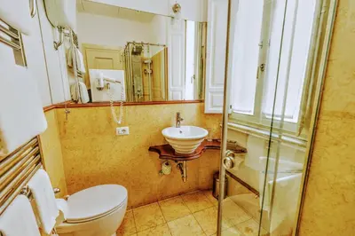 a bathroom with a toilet and a sink and a mirror at Casa Arpinelli in Rome