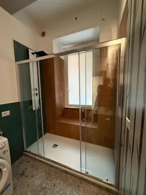a glass shower in a bathroom with a toilet at Apartment Aurum Colosseum in Rome