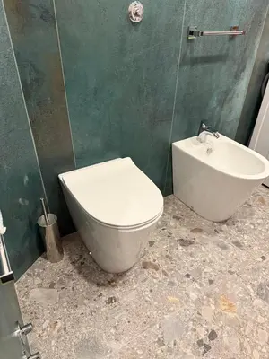 a bathroom with a toilet and a sink at Apartment Aurum Colosseum in Rome