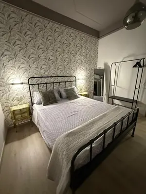 a bedroom with a bed and a wall mural at Apartment Aurum Colosseum in Rome