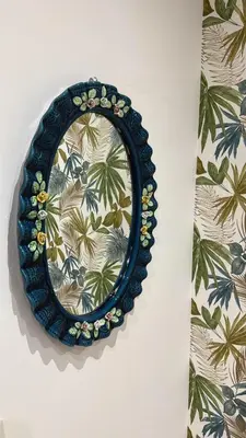 a blue plate with a mirror on a wall at Apartment Aurum Colosseum in Rome