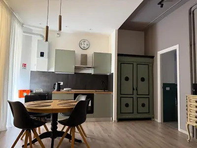 a kitchen with a table and chairs in a room at Apartment Aurum Colosseum in Rome
