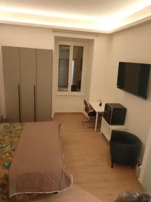 a bedroom with a bed and a tv on the wall at Igg VATICAN HOLIDAY in Rome