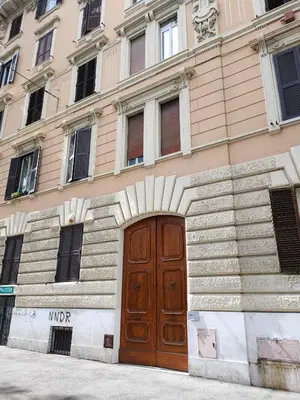 a building with a wooden door in front of it at Igg VATICAN HOLIDAY in Rome