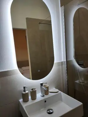 a bathroom with a white sink and a mirror at Igg VATICAN HOLIDAY in Rome