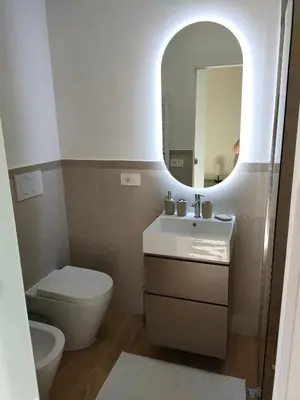 a bathroom with a toilet and a sink and a mirror at Igg VATICAN HOLIDAY in Rome
