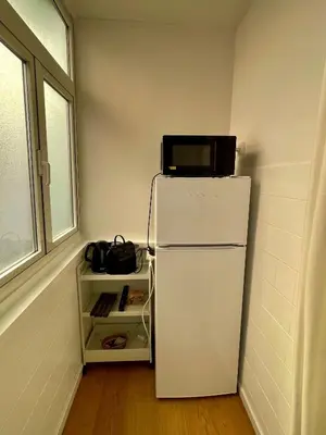 a television on top of a refrigerator in a room at San Lorenzo vivace e giovanile in Rome