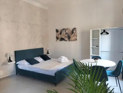 a bedroom with a bed and a table in it at Nexus Prati Suite in Rome