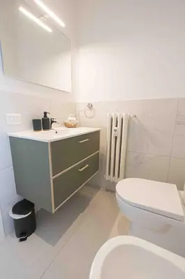 a bathroom with a white toilet and a sink at Nexus Prati Suite in Rome