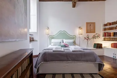 a bedroom with a large bed with a blue headboard at Rome as you feel - Vetrina Terrace in Rome