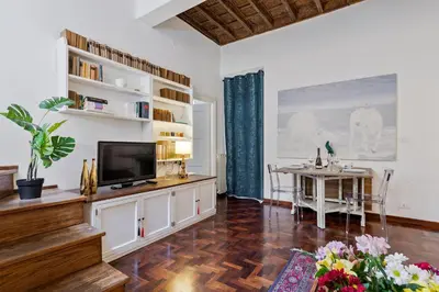 a living room with a television and a table at Rome as you feel - Vetrina Terrace in Rome