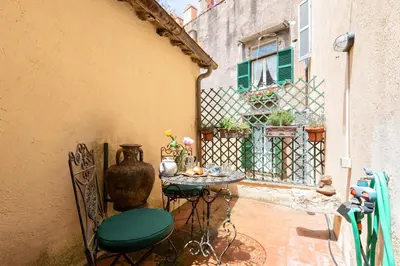 a patio with a table and chairs and a vase at Rome as you feel - Vetrina Terrace in Rome