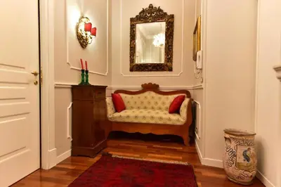 a living room with a chair and a mirror at Chez Oriana Termini St in Rome