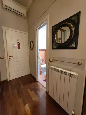 a hallway with a bathroom with a mirror and a door at Chez Oriana Termini St in Rome