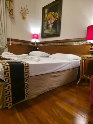 a bedroom with a large bed with a picture on the wall at Chez Oriana Termini St in Rome