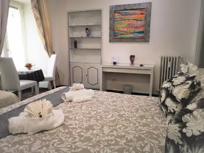 a bedroom with a bed with two towels on it at Have A Nice Holiday - Luxury Rooms in Rome