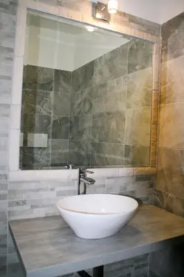 a bathroom with a white sink and a mirror at Have A Nice Holiday - Luxury Rooms in Rome