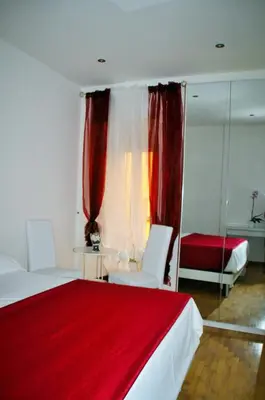 a bedroom with two beds and a red blanket at Have A Nice Holiday - Luxury Rooms in Rome
