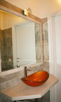 a red sink on a counter in a bathroom at Have A Nice Holiday - Luxury Rooms in Rome