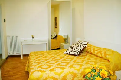 a bedroom with a bed with two pillows on it at Have A Nice Holiday - Luxury Rooms in Rome