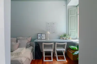 a bedroom with a bed and two chairs next to a desk at Emanuela Home - VATICAN in Rome