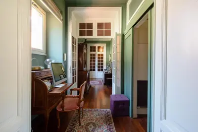 a room with green walls and a desk with a computer at Emanuela Home - VATICAN in Rome