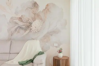 a living room with a flower mural on the wall at iFlat Modern Sunlit Studio Apt by the Colosseum in Rome