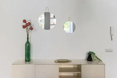 a table with a vase with flowers in it at iFlat Sleek & Sunlit Apartment near the Vatican in Rome