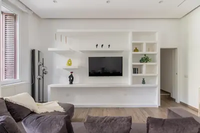 a living room with a couch and a flat screen tv at iFlat Sleek & Sunlit Apartment near the Vatican in Rome