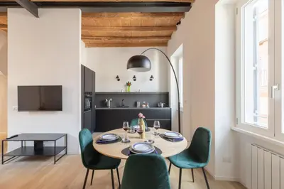 a dining room with a table and green chairs at iFlat Peaceful & Charming Hideaway near Vatican in Rome