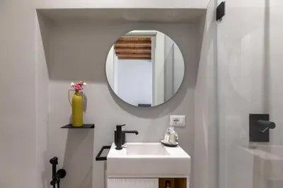 a bathroom with a sink and a mirror at iFlat Peaceful & Charming Hideaway near Vatican in Rome