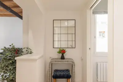 a hallway with a chair and a window at iFlat Peaceful & Charming Hideaway near Vatican in Rome